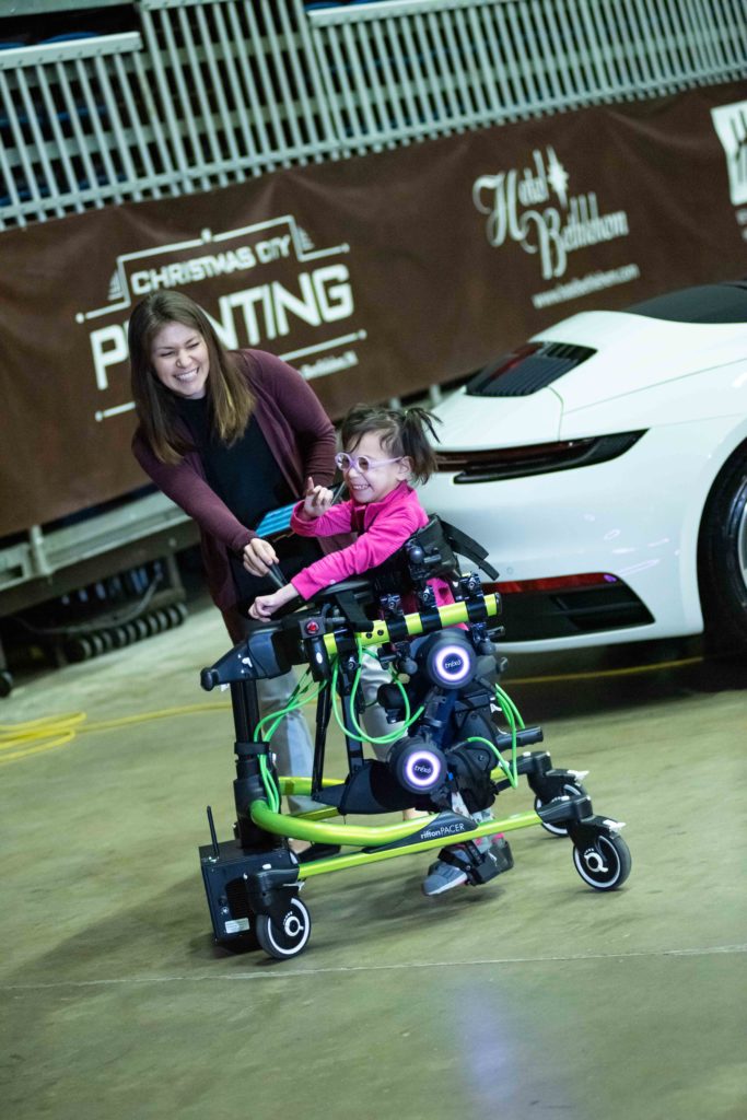 Emily Pineda demonstrates the Trexo Plus robotics technology with Kandis Jones, PT, DPT, PCS, supervisor of outpatient pediatrics at Good Shepherd Rehabilitation Network