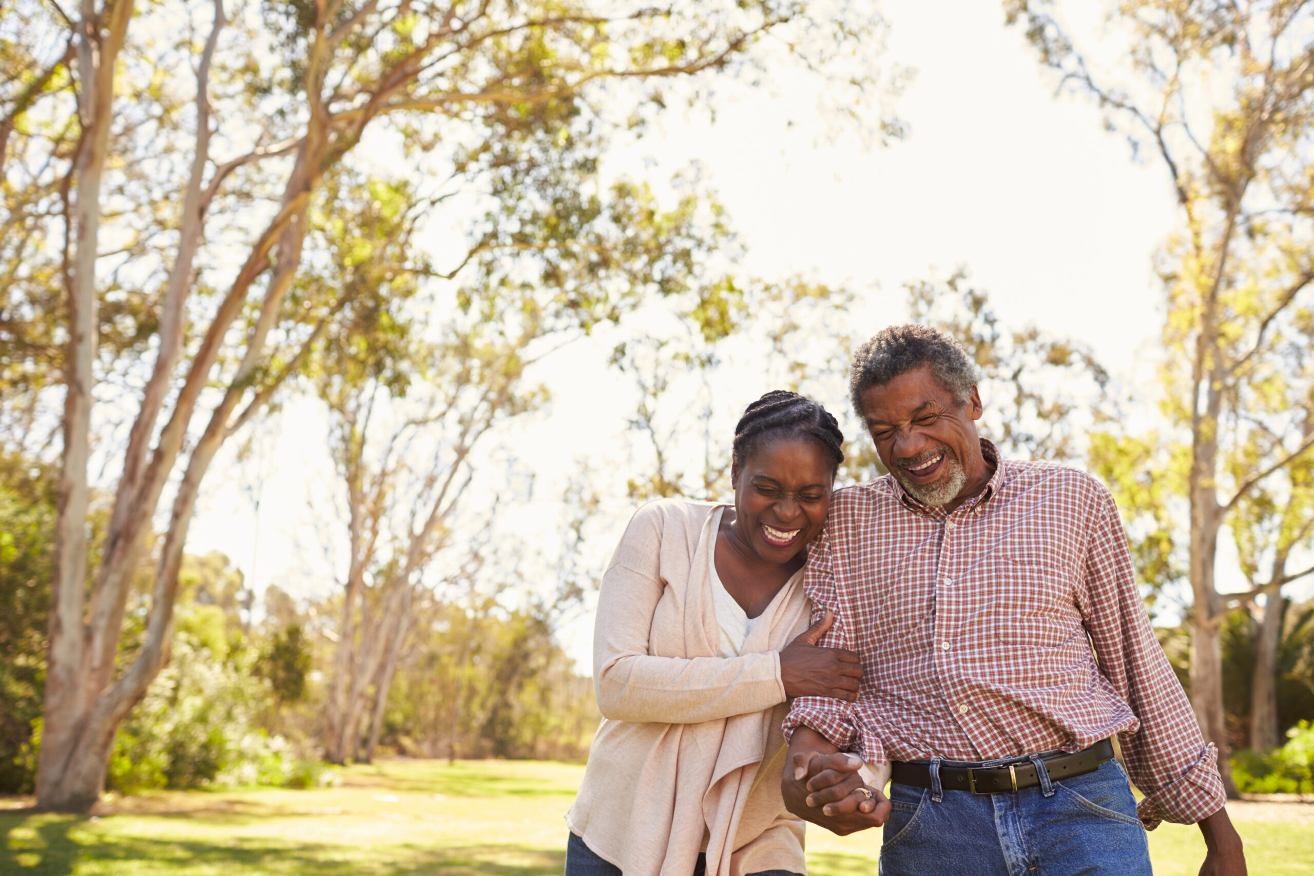 outdoor shot of a mature couple walking in the park together