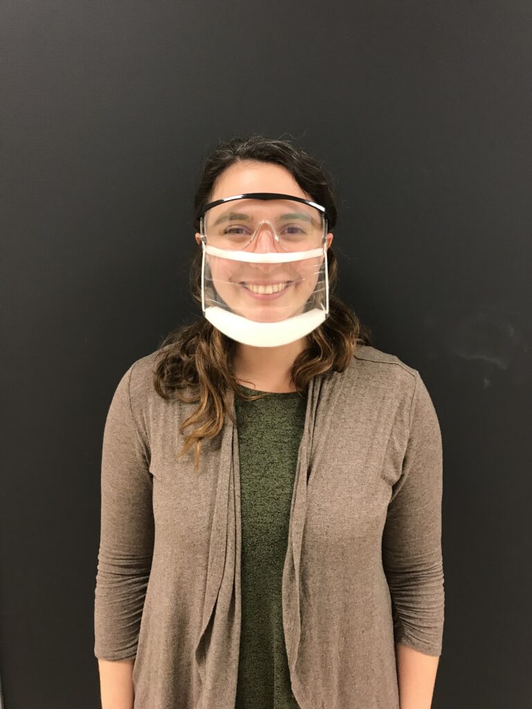 A Good Shepherd Pediatrics clinician shows a clear-mouth face mask.