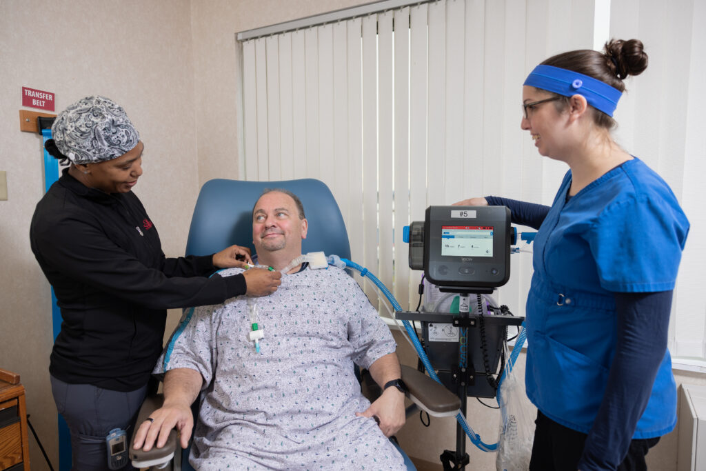 Respiratory therapist and nurse working with ventilator patient at the Good Shepherd Specialty Hospital.