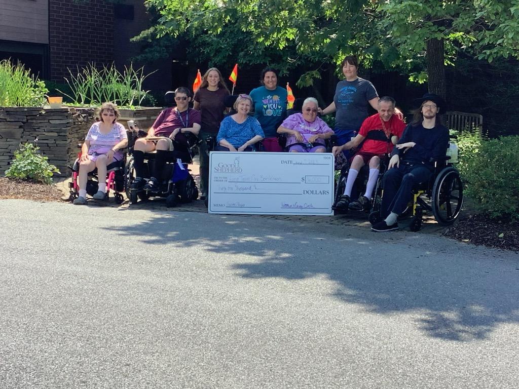 Good Shepherd Home - Bethlehem residents pose with Good Shepherd team members and a $36,000 check from Women's Giving Circle. The funds will go toward improvements to the campus garden, which is in the background.