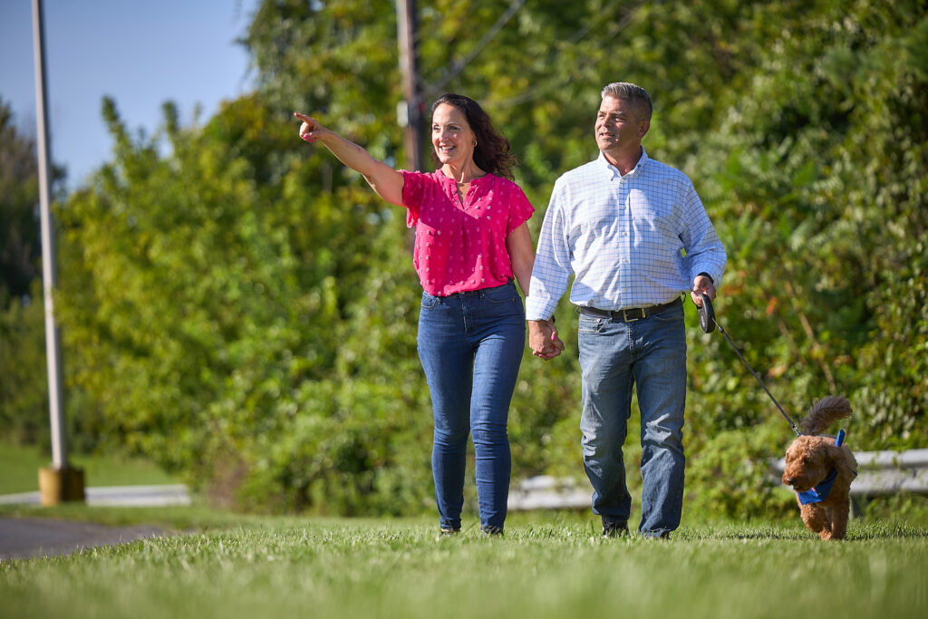 Thea Tantaros (left) walks with her husband, Keith (right), and their dog.