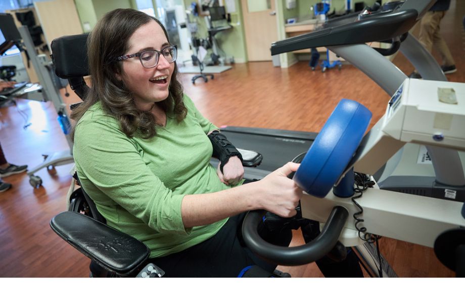 Emily Brong warms up on a bicycle during physical therapy at Good Shepherd Rehabilitation.